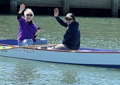 People in boat, waving