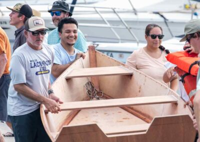 people carrying boat to water