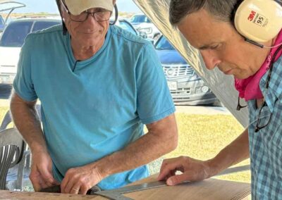 two men working on building a boat